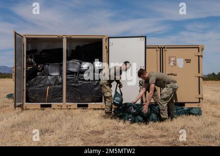 U.S. Airmen assigned to the 27th Special Operations Mission Support Group, Detachment 1, Mission Sustainment Team 2 remove and organize equipment from a storage unit during the Full Mission Profile 22-3 exercise at Sierra Blanca Regional Airport, New Mexico, March 27, 2022. The MST concept supports Agile Combat Employment strategy by providing livable conditions in contingency locations operated by multi-functional Airmen from various career fields in the 27 SOMSG. Stock Photo