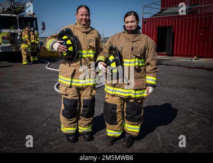 Master Sgt. Nicole Brannan (left), Department of Emergency Services senior enlisted leader with Fort Stewart-Hunter Army Airfield DES and Maj. Erin Peterson (right), operations officer with DES, suit up in firefighter equipment to cross train with the Hunter Army Airfield Fire Department. 'Having a background in military police, cross training is essential as leaders because it helps us familiarize ourselves with what our firefighters do on a daily basis and what they might need to ensure mission success,' Peterson said. Stock Photo