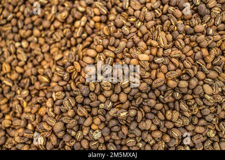 Roasted coffee beans background. Dark freshly roast coffee beans background, top view. Organic food and drink decoration texture Stock Photo