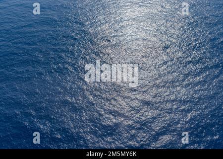 Deep blue ocean water from above. Aerial ecology Earth environment view, sunny sea water endless abstract natural scenic texture view. Small waves Stock Photo