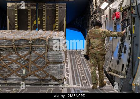 U.S. Air Force Airman 1st Class Ben Longyear, a 517th Airlift Squadron loadmaster, moves a pallet of equipment and supplies from a C-17 Globemaster III during Polar Force 22-4 at Eielson Air Force Base, Alaska, March 28, 2022. Polar Force 22-4 is led by the 3rd Wing and was designed to hone in on strategies service members require when navigating adverse situations and austere environments. Stock Photo
