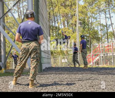 Recruits with India Company, 3rd Recruit Training Battalion learn how to descend the rappel tower with rope techniques. The 47 foot rappel tower helps recruits overcome their fear of heights and helps build confidence in their training and equipment. Stock Photo