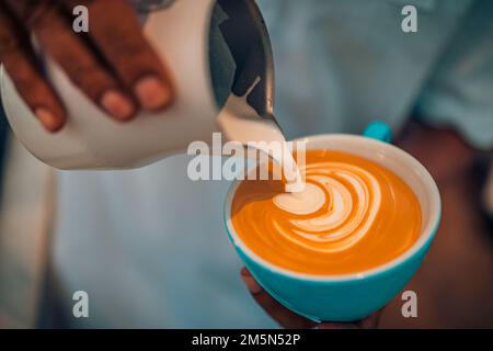 Abstract coffee shop closeup, coffee cup latte art. Barista making a cup of coffee latte art. Vintage tone some people pour milk to making latte art Stock Photo