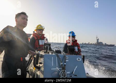 220329-N-CS075-1643 RED SEA (Mar. 29, 2022) Boatswain’s Mate 2nd Class Hunter Pemberton, center, Ensign Kyle Engelhardt, left, and Machinist’s Mate 3rd Class Ethan Stiteler, assigned to guided-missile destroyer USS Cole (DDG 67), conduct small boat operations during exercise Intrinsic Defender 22 in the Red Sea, March 29. Cole is deployed to the U.S. 5th Fleet area of operations to help ensure maritime security and stability in the Middle East region. Stock Photo