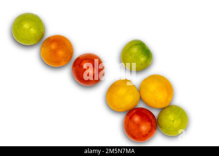 Top view of freshly harvested multi colored cherry tomatoes isolated on white background with clipping path. Stock Photo
