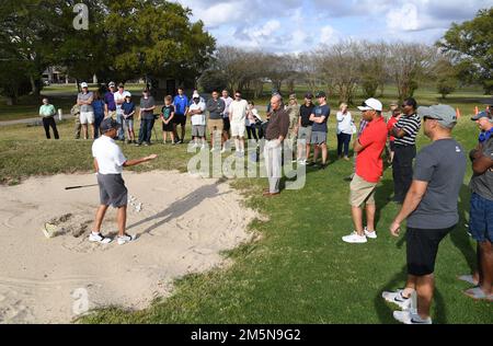 Scott Dunlap, Professional Golfers' Association champion player, provides golfing tips to Keesler personnel during a free clinic at the Bay Breeze Golf Course at Keesler Air Force Base, Mississippi, March 29, 2022. Dunlap is on the coast to compete in the 2022 Rapiscan Systems Classic at Grand Bear Golf Club. Stock Photo