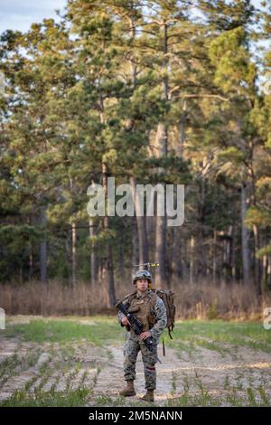 U.S. Marine Corps Sgt. Joseph Turner, a landing support specialist with Combat Logistics Battalion (CLB) 22, Combat Logistics Regiment 27, 2nd Marine Logistics Group, patrols during a simulated Tactical Recovery of Aircraft and Personnel mission on Camp Lejeune, North Carolina, March 29, 2022. CLB-22 conducted a battalion field exercise from March 28 through April 1 in order to exercise the battalion’s full range of combat service support in an expeditionary environment. Stock Photo