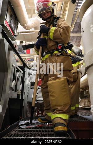 220329-N-UN585-1068 MEDITERRANEAN SEA (March 29, 2022) Damage Control Fireman Juan Ruelas, assigned to the Arleigh Burke-class guided-missile destroyer USS Ross (DDG 71), checks for structural damage as he moves through the ship's main engine room during a main space fire drill, March 29. Ross, forward-deployed to Rota, Spain, is on its 12th patrol in the U.S. Sixth Fleet area of operations in support of regional allies and partners and U.S. national security interests in Europe and Africa. Stock Photo
