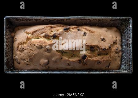 An English cake in a baking dish on a wooden board and a white wooden  table. Selective focus Stock Photo - Alamy