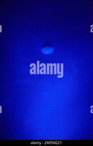 Tiled Pool Blue Illuminated at Night Stock Photo