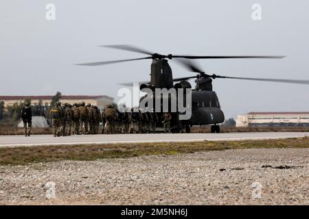 In preparation for Exercise Orion, members of Cyprus Special Operations Forces (SOF), U.S. SOF and Greek SOF load into a Greek CH-47 Chinook for airborne operations in Elefsina, Greece, March 29, 2022. Exercise Orion reinforces Greece as a regional SOF leader, enhances interoperability across multiple domains, and strengthens relationships with NATO and non-NATO partners. The exercise focuses on highlighting operational capabilities, international collaborations and conventional and hybrid warfare training. Stock Photo