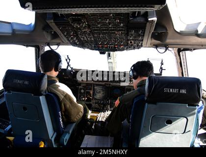 U.S. Air Force Capt. James Pyjas and U.S. Air Force Lt. Col. Charles Sendral, pilots assigned to the 105th Airlift Wing, fly a C-17 Globemaster during a flight training exercise over Syracuse, New York, Feb. 24, 2022. The training exercise was conducted in coordination with the 174th Attack Wing with the purpose of integrating dissimilar assets throughout the New York Air National Guard. Stock Photo