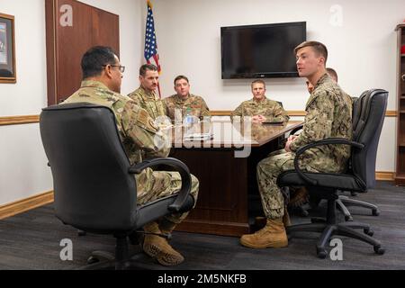 Lt. Col. Javier Velazquez, 819th RED HORSE Squadron commander, left, leads a discussion about   efficient engineering with U.S. Army and U.S. Navy personnel Feb. 25, 2022, at Malmstrom Air Force Base, Mont. Engineers from the 819th RHS and the other branches compared best practices during the week of training together. Training opportunities with other branches allow the 819th RHS to develop a better understanding of their capabilities, while increasing their efficiency in deployed environments. Stock Photo