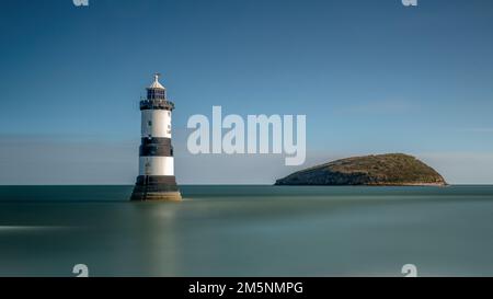 Penmon Point Lighthouse on the Anglesey coast in North Wales, overlooking the Menai Strait and Puffin Island. Stock Photo