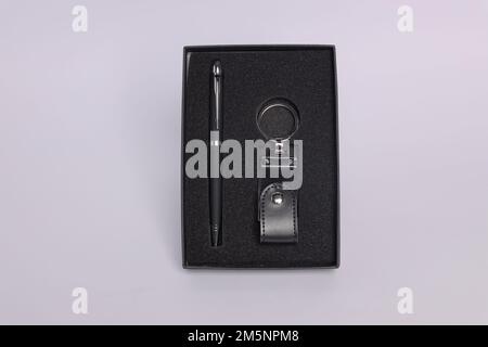 Customized corporate gift box mock up image, Personalised metal pen with mobile stylus, Customized leather keychain , Black color concept corporate gi Stock Photo