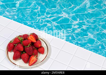 Strawberry platter on the pool and marble floor Stock Photo