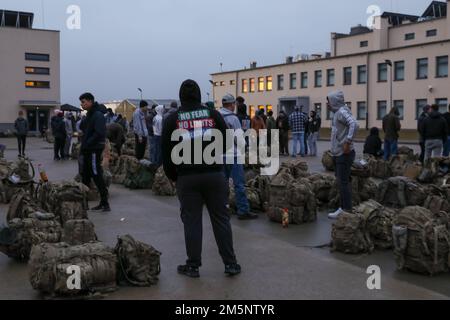 Soldiers assigned to 2nd Battalion, 34th Armored Regiment “Dreadnaughts” wait for the bus to arrive at Drawsko Pomorskie Training Area, Poland, Feb. 26, 2022. These Soldiers make up part of the 13,000 participants taking part in Saber Strike 22. Stock Photo