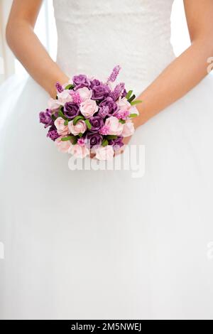 The beautiful bride holding flowers Stock Photo