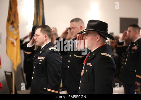 Soldiers assigned to 27th Infantry Brigade Combat Team, New York Army National Guard, present arms during the National Anthem, at a dining in for the brigade's senior leaders in Syracuse, New York, February 26, 2022. The dining in was part of a leaders workshop weekend, which served to prepare the IBCT for upcoming deployments and development of its future forces. Stock Photo