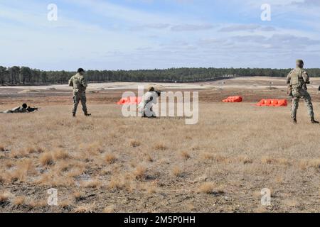 These soldiers from the 1st Battalion 69th Infantry, NYARNG completing fire and maneuver exercise on Range 47B on the Fort Dix Range Complex. During this training each platoon is expected to maneuver using cover through fire towards a flank of an enemy machine gun or strongpoint. When advancing, the 1st Half-Platoon would keep the enemy position busy with supporting weapons fire while the 2nd Half-Platoon would maneuver to a flank, or rear, and roll up the threat. (Photos taken by the Fort Dix [TSC] Training Support Center) Stock Photo