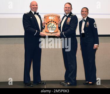 U.S. Air Force Col. Matthew Reilman, 17th Training Wing commander, presents an award to Lt. Col. John Bergmans, 315th Training Squadron commander and proxy to the Key Spouse of the Year award recipient, during the 29th Annual Awards Ceremony at the McNease Convention Center, San Angelo, Texas, Feb. 26, 2022. The 315th TRS also garnered the Unit of the Year award. Stock Photo