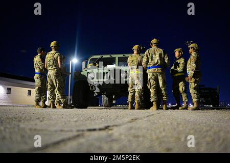 U.S. Airmen with the 156th Contingency Response Group, 156th Wing, Puerto Rico Air National Guard, discuss the training plan that includes night driving, identifying distances in blackout conditions and convoying without night vision devices, during Southern Strike at Gulfport Combat Readiness Training Center, Gulfport, Mississippi, April 26, 2022. Southern Strike 2022 is a large-scale, joint multinational combat exercise hosted by the Mississippi National Guard that provides tactical level training for the full spectrum of conflict. Stock Photo