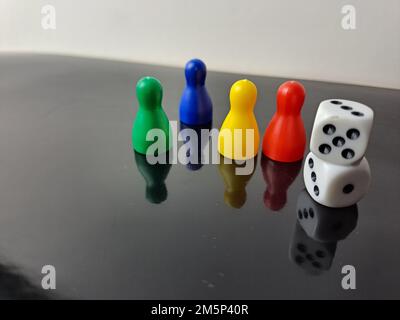 Board Game Pawns And Dice With Colored Pieces Stock Photo