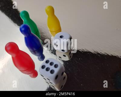 Board Game Pawns And Dice With Colored Pieces Stock Photo