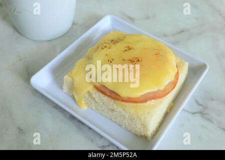 cured ham, egg and bread and cup of tea on table  Stock Photo