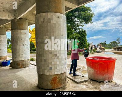 Khao Tut, Phuket, Thailand, Woman, Thai Workers, Working on Construction Site,  Buddhist Temple, Statue, 'Big Buddha' (Ming Mongkol) Stock Photo