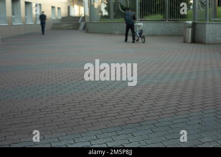 Area in city. Tile on road. Tile coating of area. Street details on summer day. Stock Photo