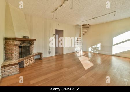 an empty living room with wood floors and a brick fireplace in the room is very clean, but it's hard to see Stock Photo