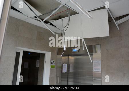 View of the damaged apartment building in Kyiv, which suffered from a kamikaze drone attack by the Russian Federation. An apartment building in Kyiv was damaged by a kamikaze drone attack by the Russian Federation on the night of December 30, 2022. According to the Air Defense Forces, 7 kamikaze drones were heading for Kyiv. 2 of them were shot down on the approach to the capital, 5 over Kyiv. As a result of the fall of one drone, windows in a residential building and in one non-residential building were damaged in the Holosiiv district. Stock Photo