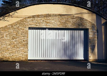 White automatic garage doors opening horizontally Stock Photo