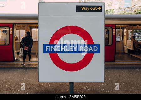 London, UK - December 26, 2022: Roundel name sign at the outdoor platform of Finchley Road station of London Underground, the oldest underground railw Stock Photo