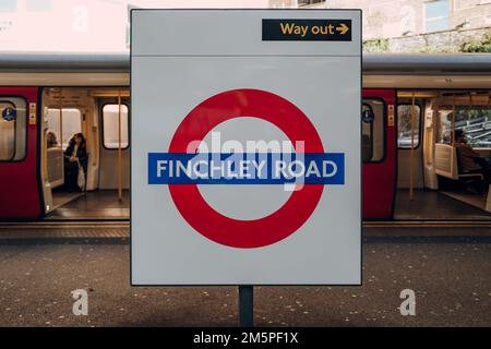 London, UK - December 26, 2022: Roundel name sign at the outdoor platform of Finchley Road station of London Underground, the oldest underground railw Stock Photo