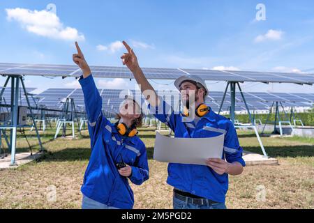 Maintenance engineer at solar farm looking drawing discuss on expansion upgrade electricity plant Stock Photo