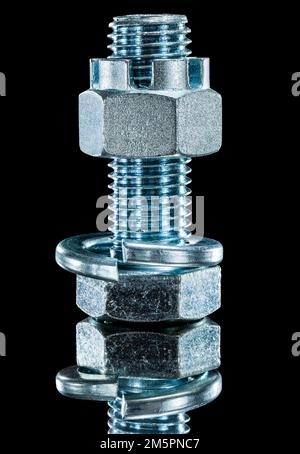 Construction nut screwbolt spring washer on black surface. Stock Photo