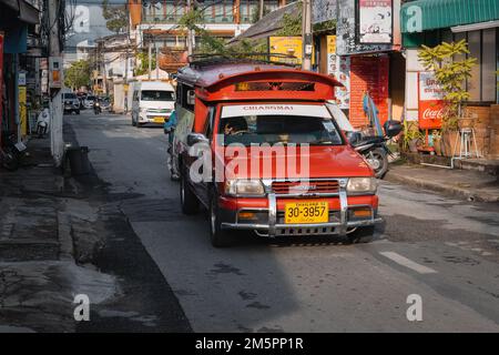 Chiang Mai, Thailand. November 18, 2022. Songthaew or 'red car'. Traditional taxi on the street of Chiang Mai Stock Photo