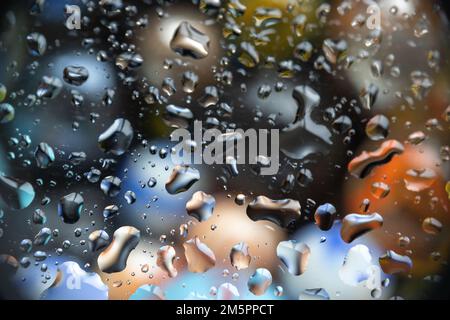 Beautiful water drops on glass, with a colored background, suitable as a background or overlay Stock Photo