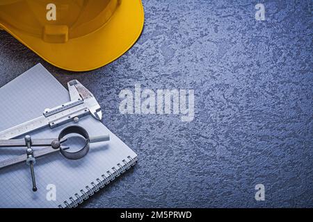 Notebook building helmet compasses vernier scale construction concept. Stock Photo