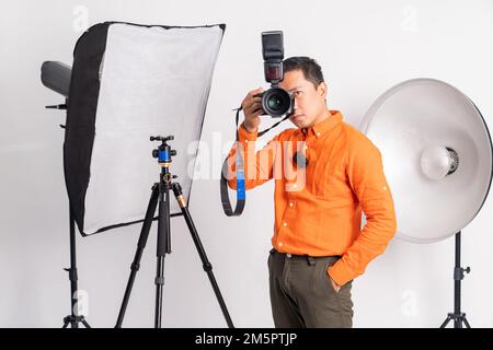 man using camera to take photo when hands in pocket Stock Photo