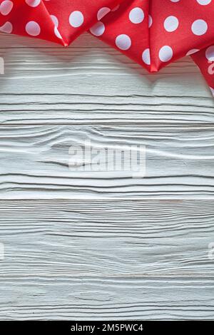 Red cotton polka-dot fabric on wooden board. Stock Photo