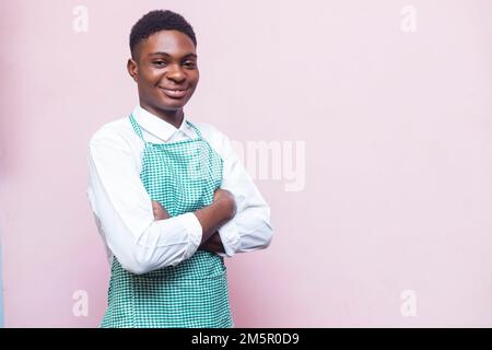 An African man wearing apron in white background Stock Photo
