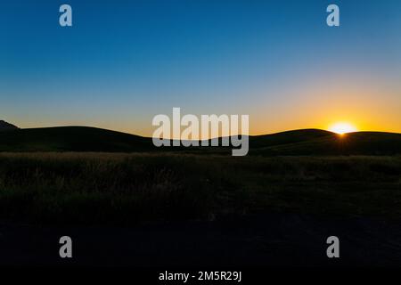 Beautiful sunset over rolling farm fields; Palouse region; Washington state; USA Stock Photo