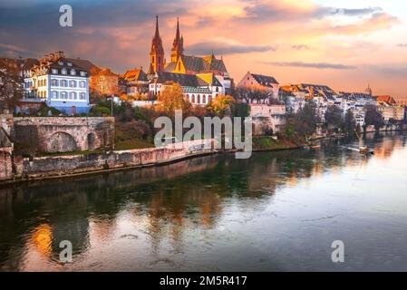 Basel, Switzerland. Beautiful city on Rhine River banks with Munster Cathedral sunset colors. Charming Swiss landscape. Stock Photo