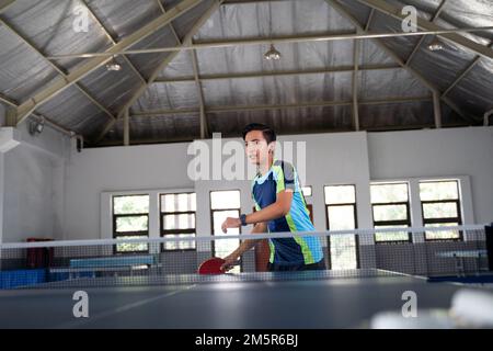 Asian male athlete ready to receive ball Stock Photo
