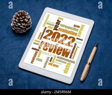 2022 year review word cloud on a digital tablet, end of year business analysis concept Stock Photo