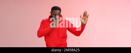 Guy knows asian fighting skills. Portrait serious-looking funny african-american young man perform martial arts standing kung-fu karate pose raised Stock Photo