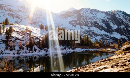 Still hidden lake far above Big Cottonwood Canyon's winding road Stock Photo